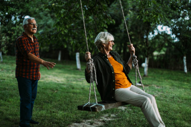 istock Elderly couple fun with swing 1390976585