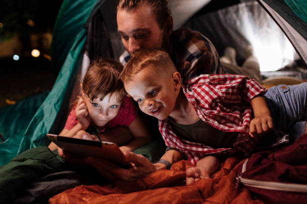 istock Happy family lying in a tent 1390976598
