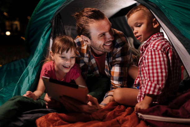 istock Laughing with dad in tent 1390976601