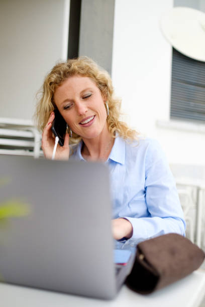 istock Woman working from a beach terrace, on a smartphone call 1390978039