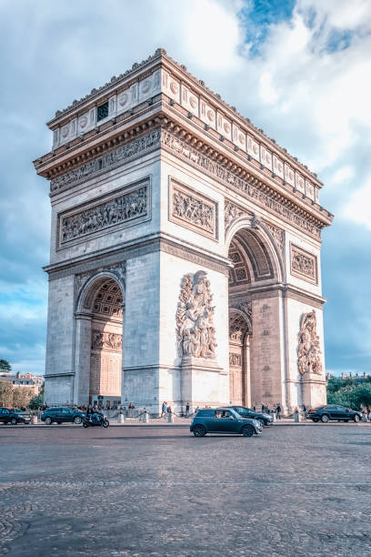 Architecture in Paris Arc De Triomphe in Paris in daytime musee du louvre stock pictures, royalty-free photos & images