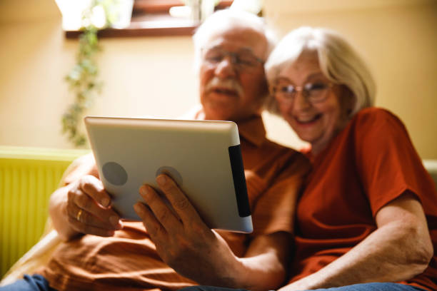 istock Senior couple relaxing, bonding and using digital tablet together 1390979433