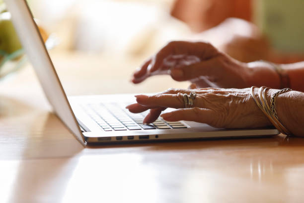 istock Unrecognizable senior woman typing something on laptop keyboard 1390980012