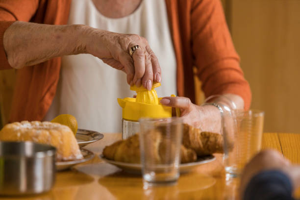 istock Midsection of senior woman squeezing a lemon for lemonade 1390980618