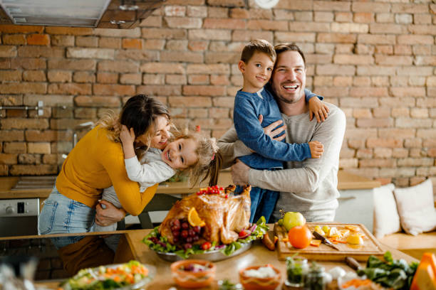istock Happy family having fun during Thanksgiving day in the kitchen. 1390981440