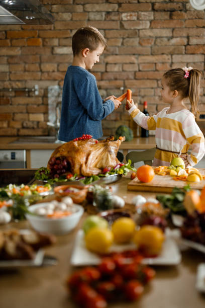 istock Little siblings having fun during Thanksgiving day in the kitchen. 1390981497