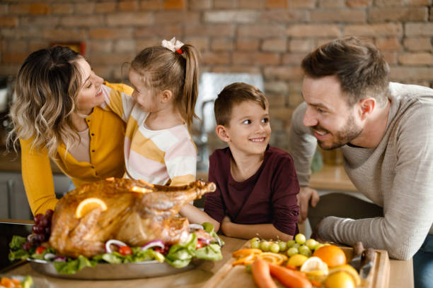 istock Happy family talking during Thanksgiving day in the kitchen. 1390981590