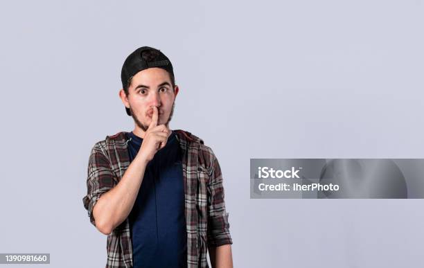 Man Gesturing To Keep Quiet Guy With Finger On Mouth Showing Hush Gesture Hush Please Concept Stock Photo - Download Image Now
