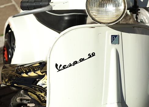 Udine, Italy. April 10, 2022. Vespa 50 logo on the white front faitring. It's one of the most selled model of the famous scooter  Vespa produced by Piaggio motorcycles manufacturer
