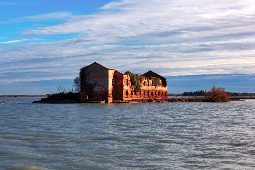 Old brick ruins of the Madonna del Monte in Venetian Lagoon near Burano and Torcello island, Venice, Italy