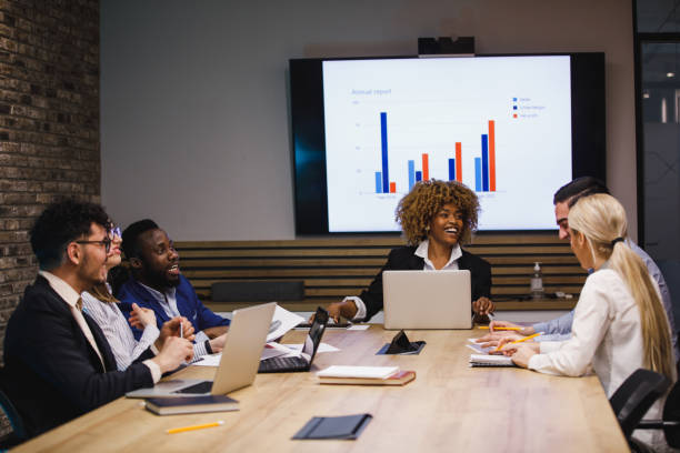 istock Group of diverse business people having fun discussing data during a project meeting 1390983725