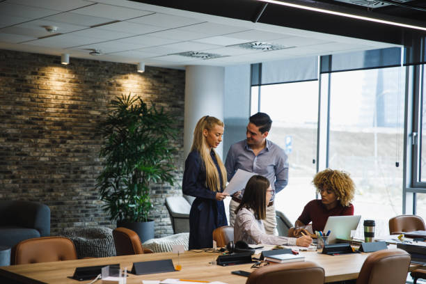 istock Group of four young business colleagues having a quick briefing 1390983853