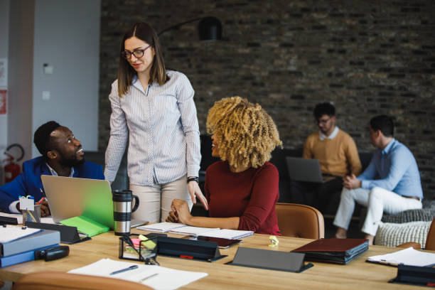 istock Group of young business people co-working in a modern, open plan office space 1390983878