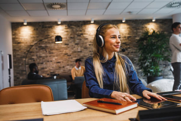istock Female customer service representative smiling and looking away while on a call 1390984002