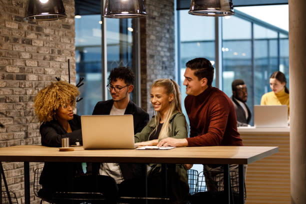 istock Team of young business people analyzing data on laptop and discussing given information 1390984015