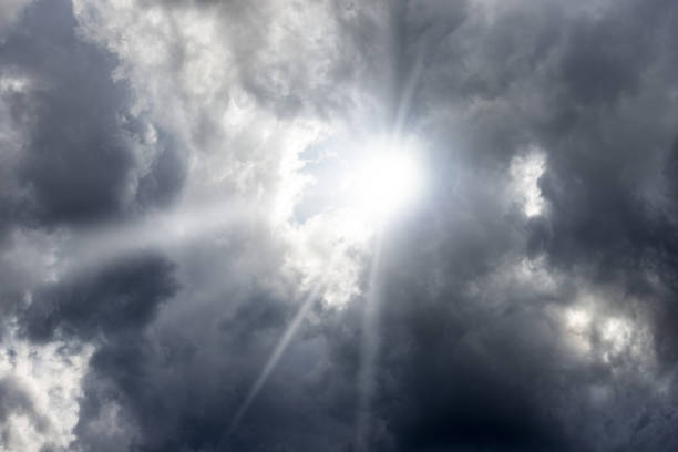 istock Dark Cloudy Sky with Sunbeams - Full Frame Photography 1390984029