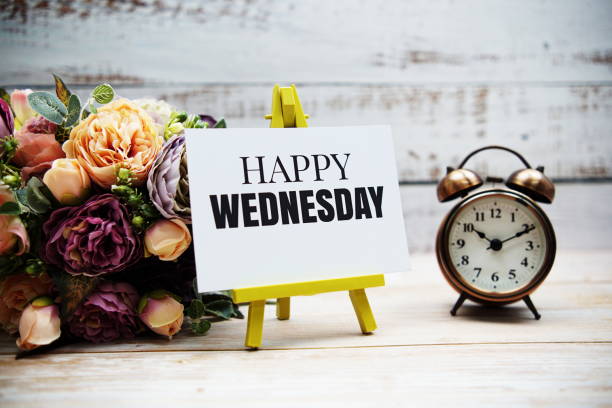 Happy Wednesday text with flower bouquet and alarm clock on wooden background Happy Wednesday text with flower bouquet and alarm clock on wooden background wednesday morning stock pictures, royalty-free photos & images