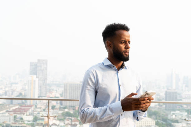 istock Portrait of handsome young African man using mobile phone 1390986281