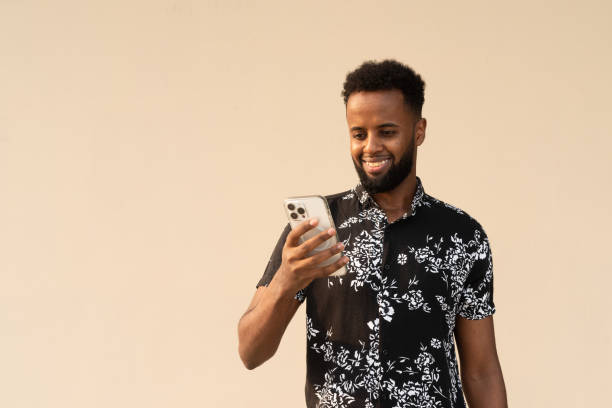 istock Portrait of handsome young African man using mobile phone 1390986344