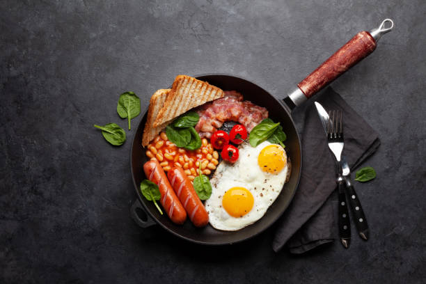 istock English breakfast with fried eggs, beans, bacon and sausages 1390987107