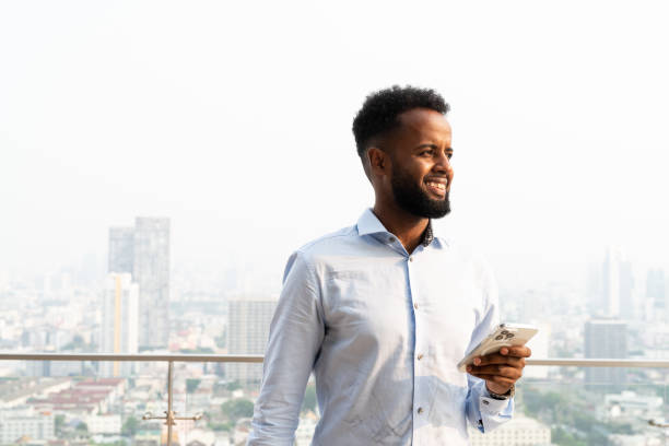 istock Portrait of handsome young African man using mobile phone 1390987316