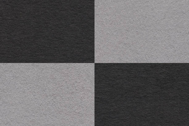 istock Texture of craft gray and black paper background with cells pattern, macro. 1390990313