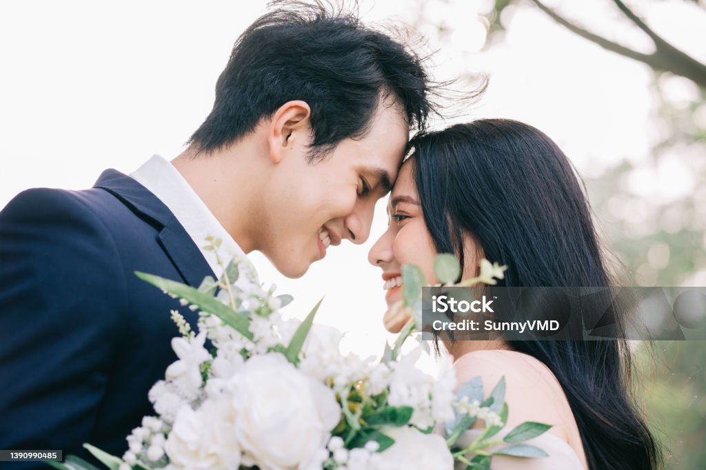 Image of young Asian bride and groom Wedding Stock Photo