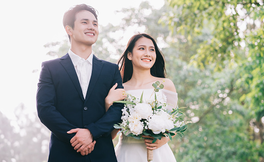 Image of young Asian bride and groom