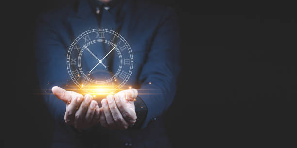 istock Businessman holding clock. Business time management . 1390990563