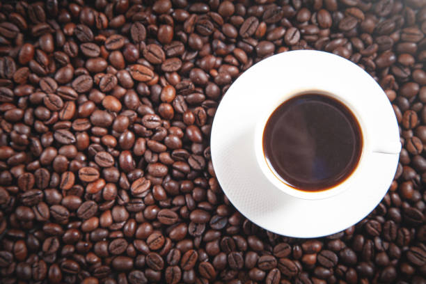 Cup of coffee on coffee beans.