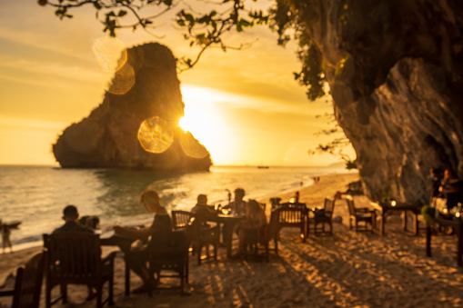 blur of restaurant cave on Phra nang Beach at sunset, Railay, Krabi, Thailand. vacation, travel, summer, Wanderlust and holiday concept