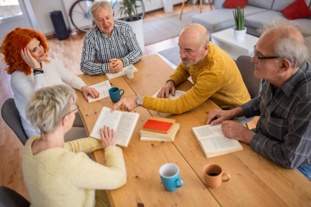istock Senior Caucasian people reading and discuss the reference book 1390991665