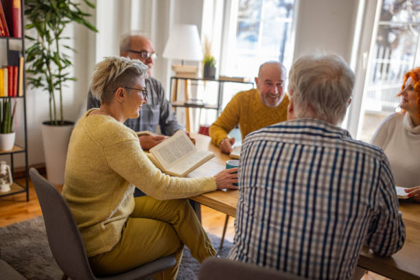 istock Senior friends reading and discuss the reference book, during book reading meeting 1390992283