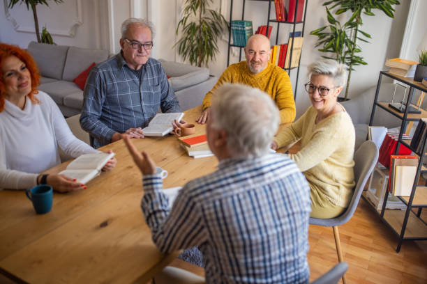 istock Senior man leading the book reading meeting 1390992947