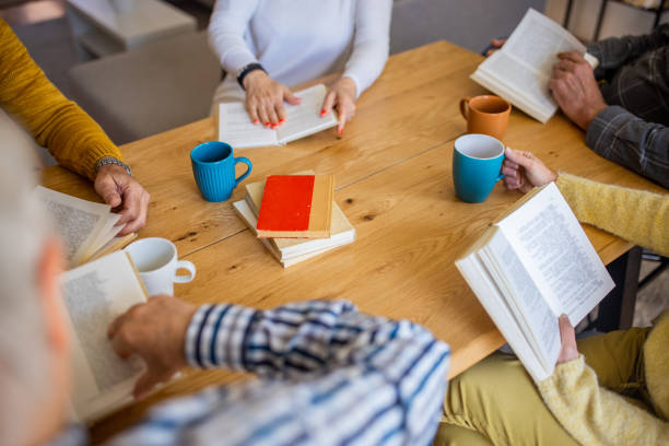 istock Unrecognizable people reading books, during book club meeting 1390993017