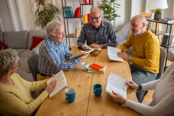 istock Senior people reading and discuss the reference book, during book reading meeting 1390993113