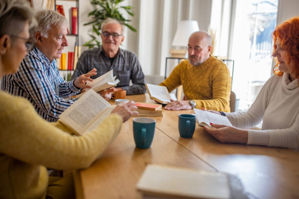 istock Caucasian people reading and discuss the reference book, during book reading meeting 1390993232