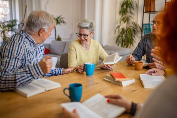 istock During book club meeting, Caucasian senior people discuss the reference book 1390993325