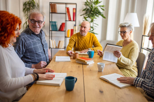 istock Senior Caucasian people reading and discuss the reference book 1390993457