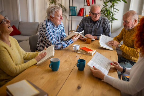 istock Senior people reading and discuss the reference book, during book reading meeting 1390993617