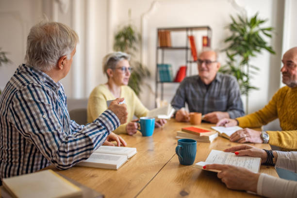 istock During book club meeting, senior people discuss the reference book 1390993618