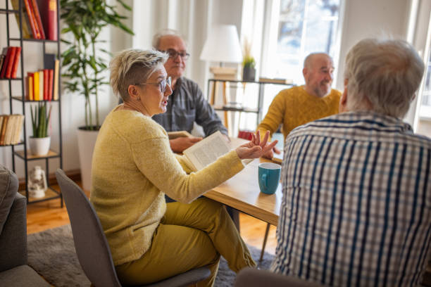 istock Senior people reading and discuss the reference book, during book reading meeting 1390994299