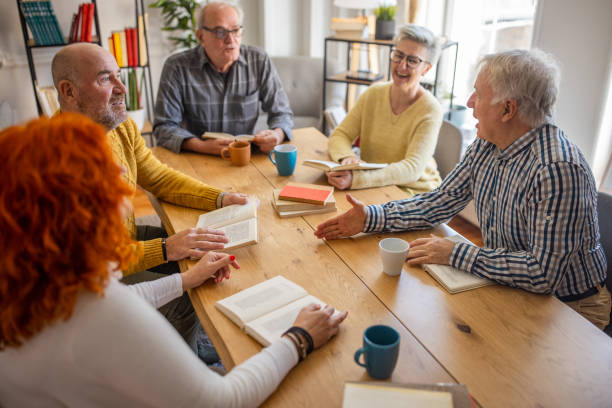 istock During book club meeting, curious senior people discuss the reference book 1390994301