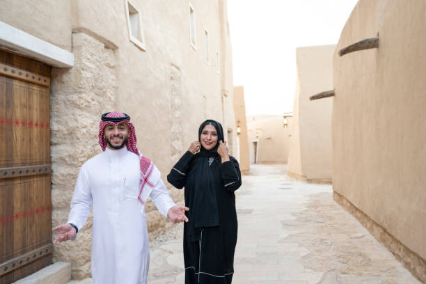 istock Three quarter candid view of Saudi couple approaching camera 1390994402