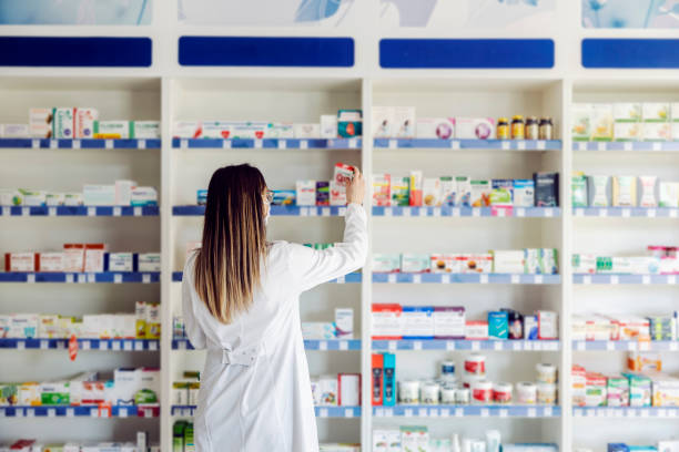 istock An apothecary worker looking at medicines in pharmacy. 1390994422