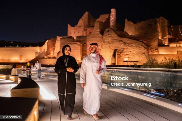 Mid Adult Saudi Couple Exploring Open Air Museum At Night Stock Photo - Download Image Now