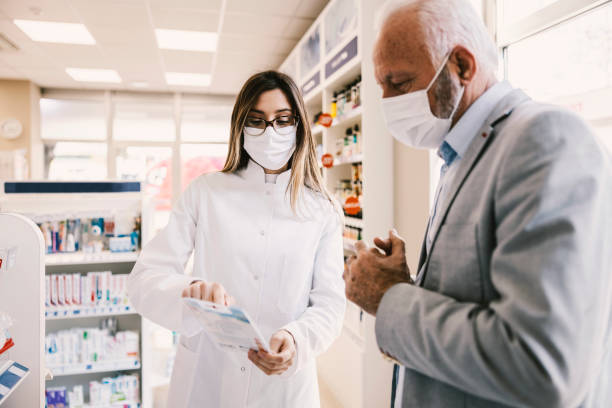 istock An old man asking for opinion apothecary worker about baby bottles. 1390994488