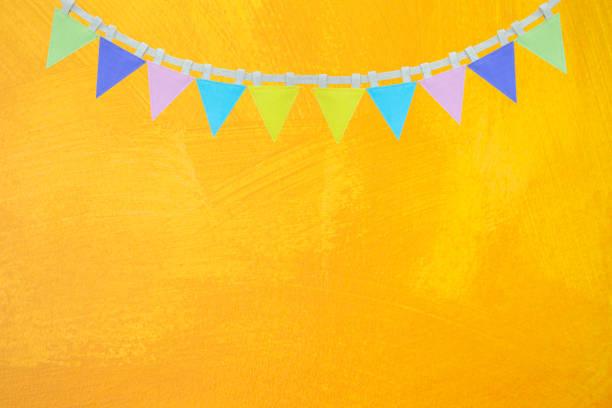 istock Flag garland on abstract yellow paint wall texture background 1390994517