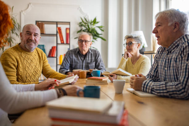 istock During book club meeting, curious senior people discuss the reference book 1390994580