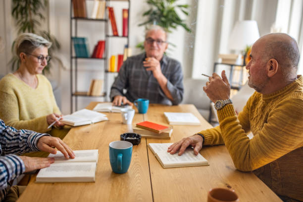 istock Senior people reading and discuss the reference book, during book reading meeting 1390994832